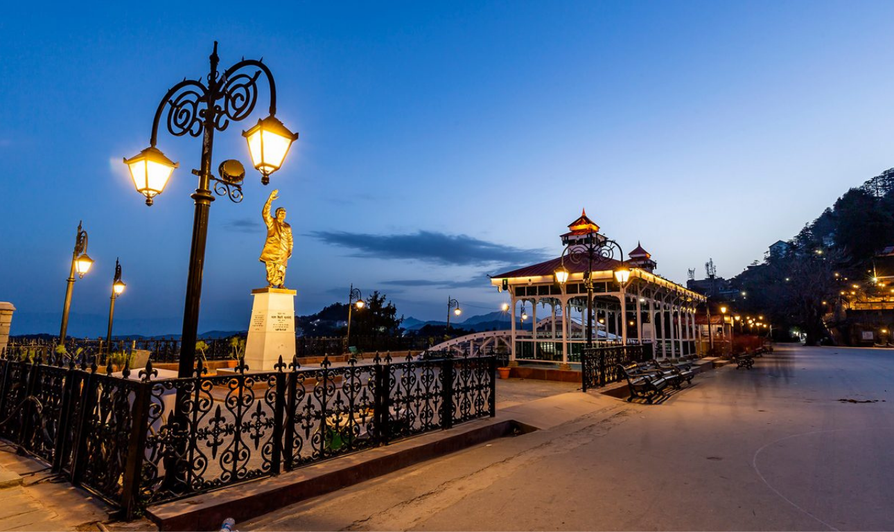 Beautiful view of Shimla with colonial buildings, green hills, pine forests, and scenic Himalayan mountain landscapes under a clear blue sky.