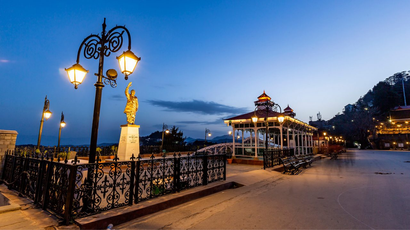 Beautiful view of Shimla with colonial buildings, green hills, pine forests, and scenic Himalayan mountain landscapes under a clear blue sky.