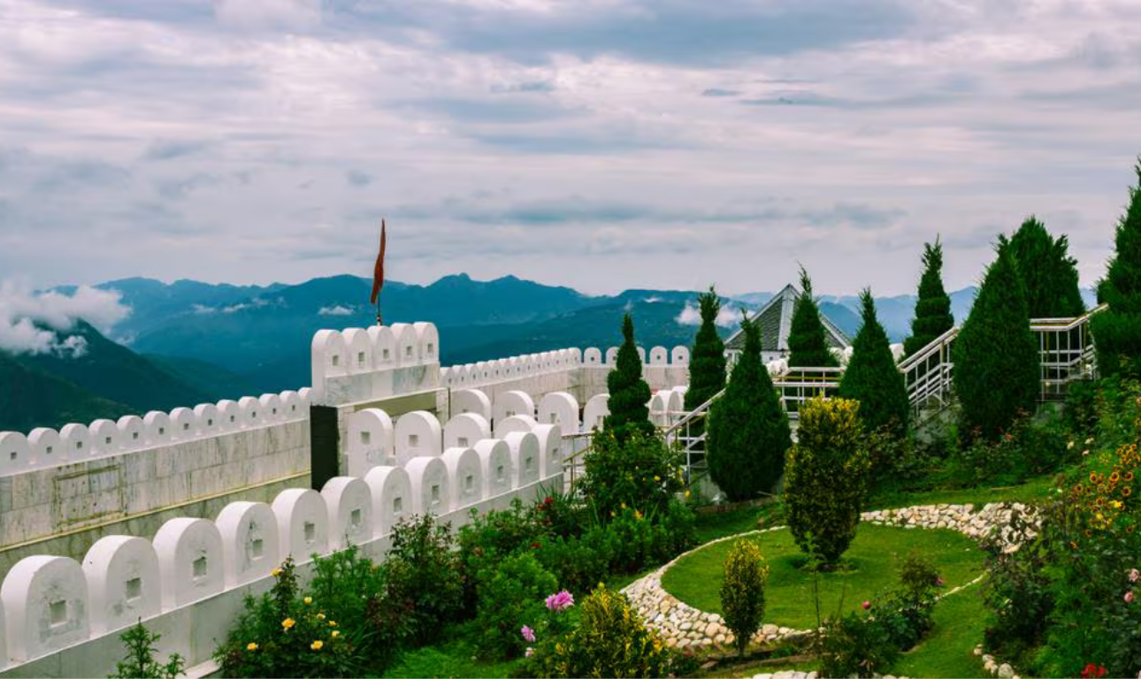 Beautiful landscape of Chail featuring lush green hills, dense pine forests, scenic mountain views, and peaceful surroundings under a clear blue sky.