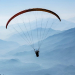 Paragliding adventure over the scenic mountain valleys of Bir Billing with breathtaking views of the Himalayas.