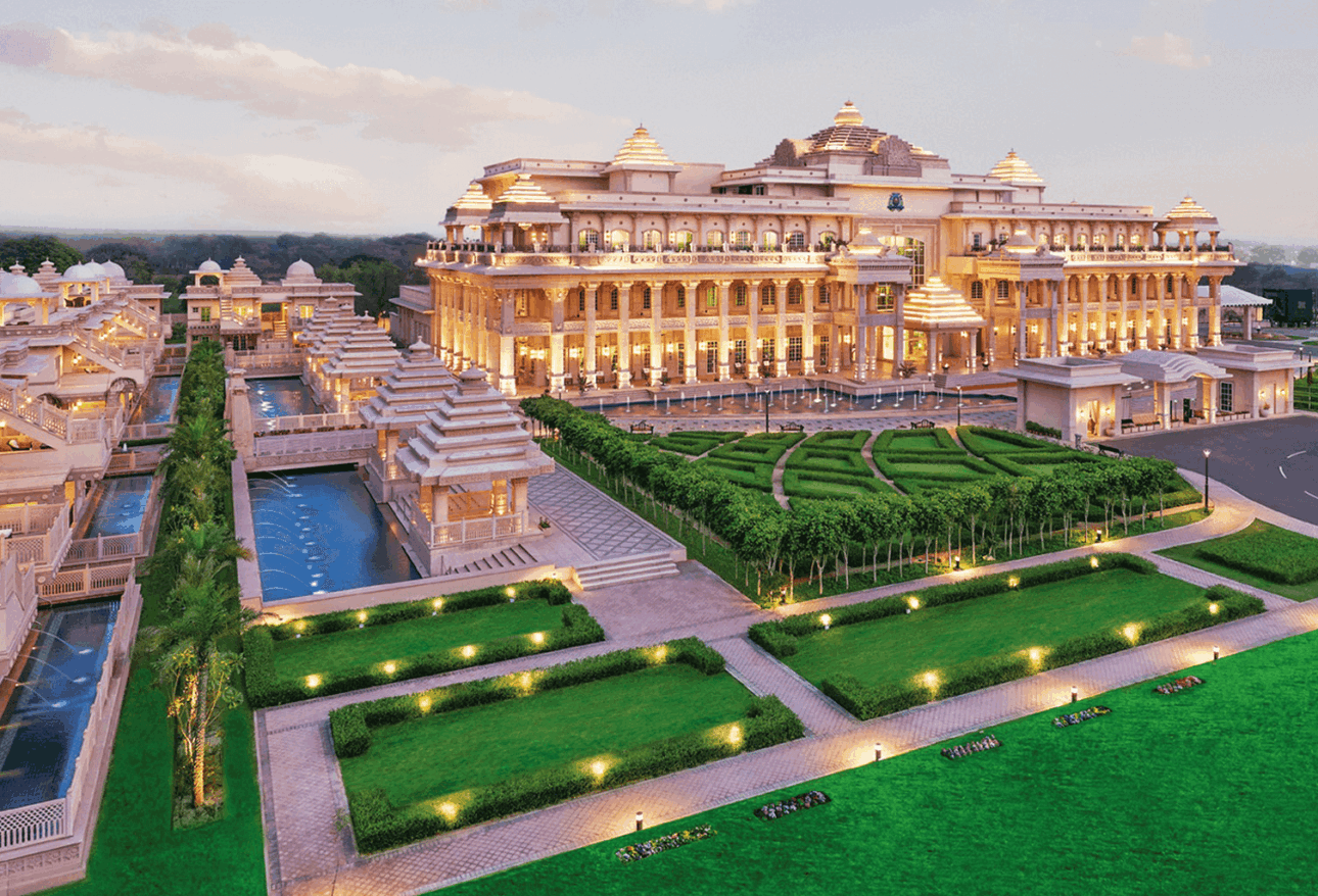 Luxury resort near Delhi with grand palace-style architecture, beautiful gardens, glowing lights, and romantic ambiance for couples.