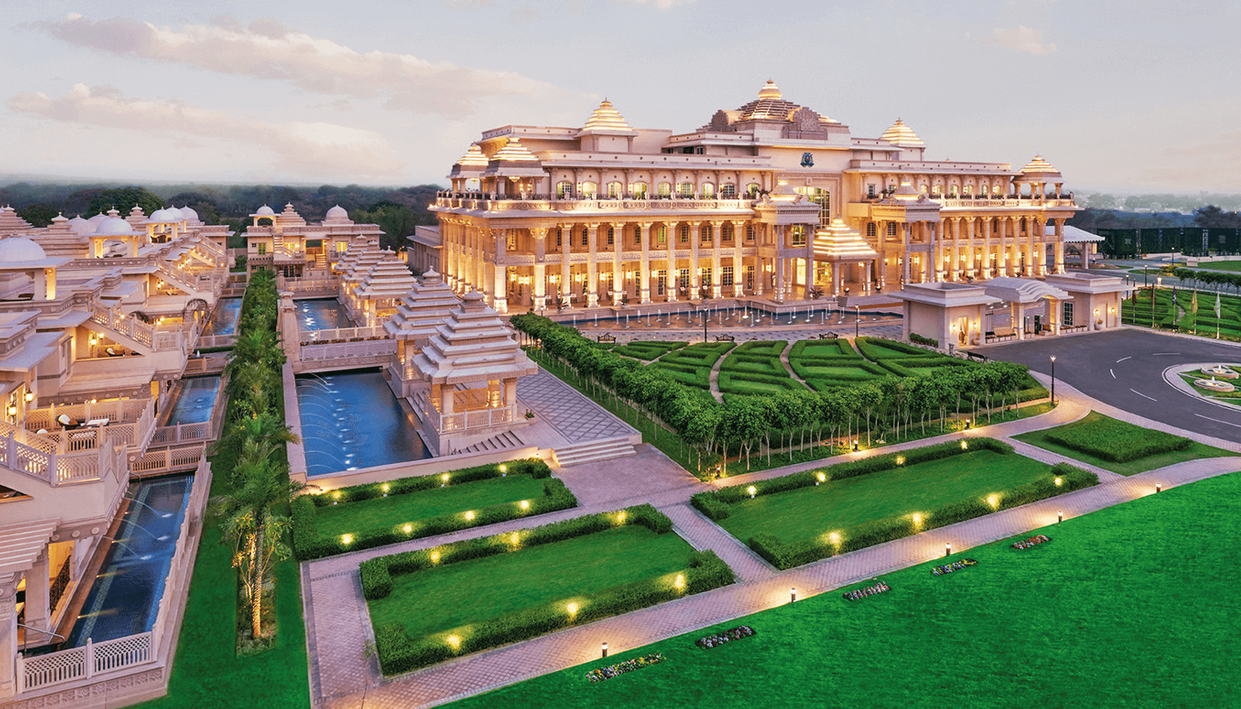 Luxury resort near Delhi with grand palace-style architecture, beautiful gardens, glowing lights, and romantic ambiance for couples.