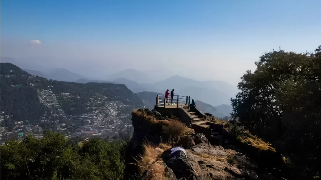 Panoramic view from Tiffin Top in Nainital overlooking forests and mountains.